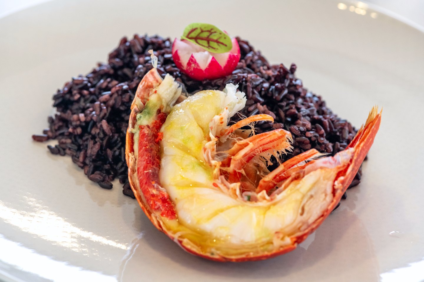 Grilled lobster with saffron butter on black rice