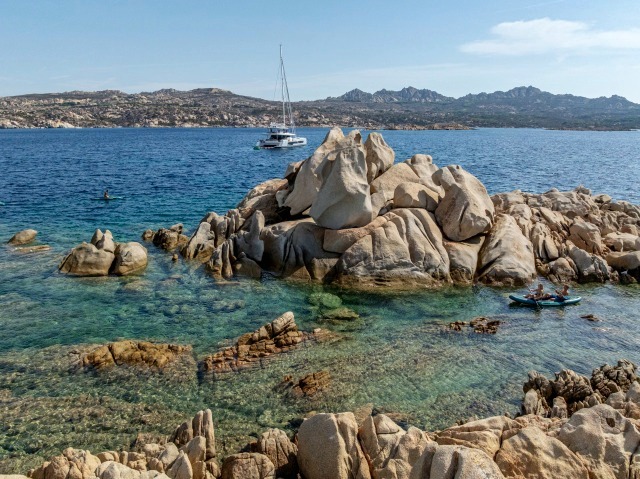 Kayak by the granite rocks of La Maddalena, WINDKIND at anchor