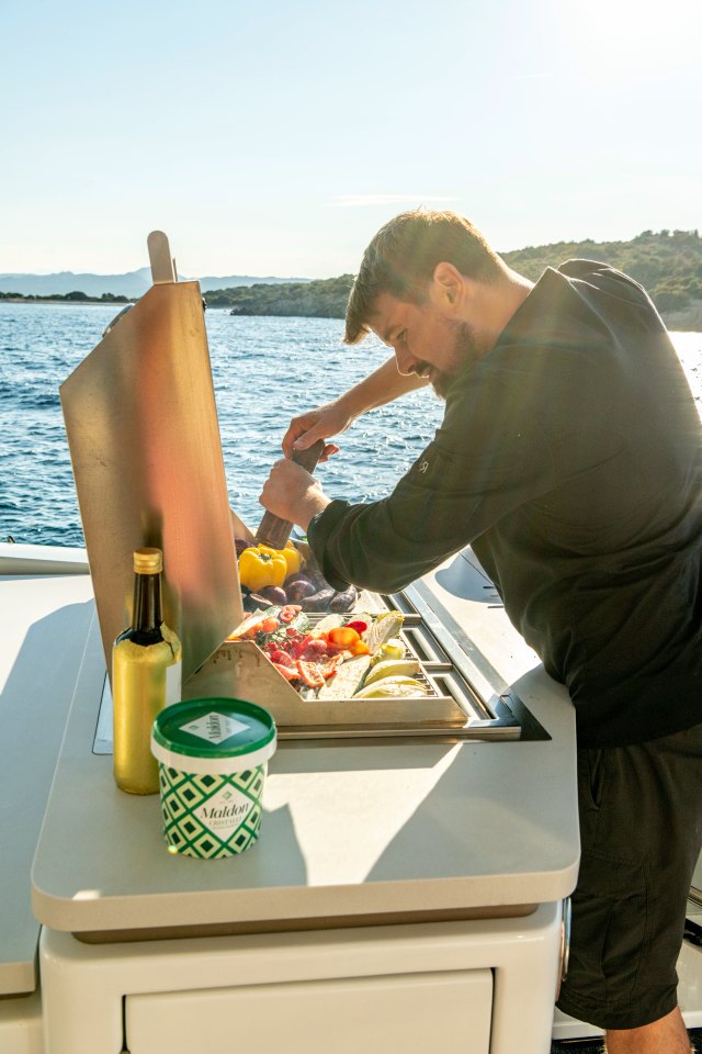 Chef seasoning at the grill